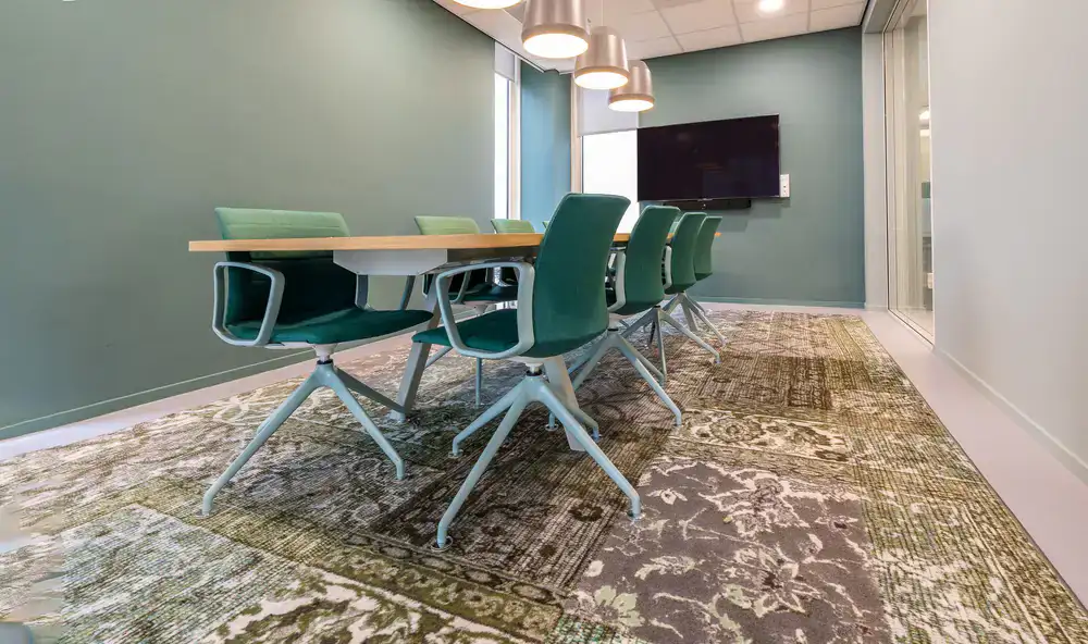 Meeting room featuring a lush green divider wall